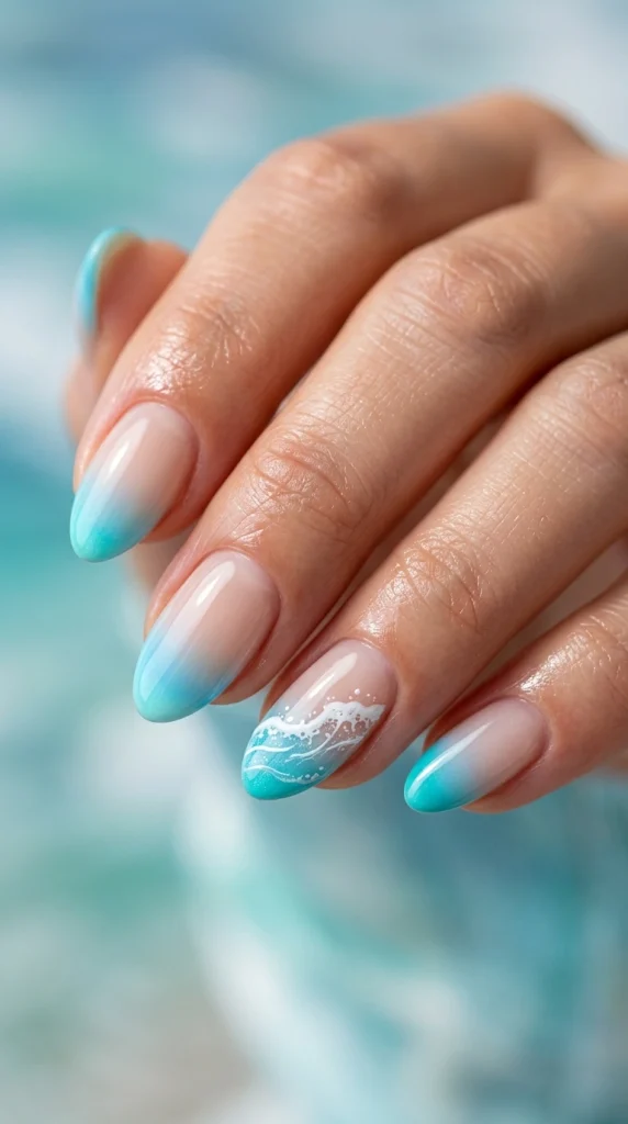 Close-up of almond nails with turquoise and sky blue ombré French tips.