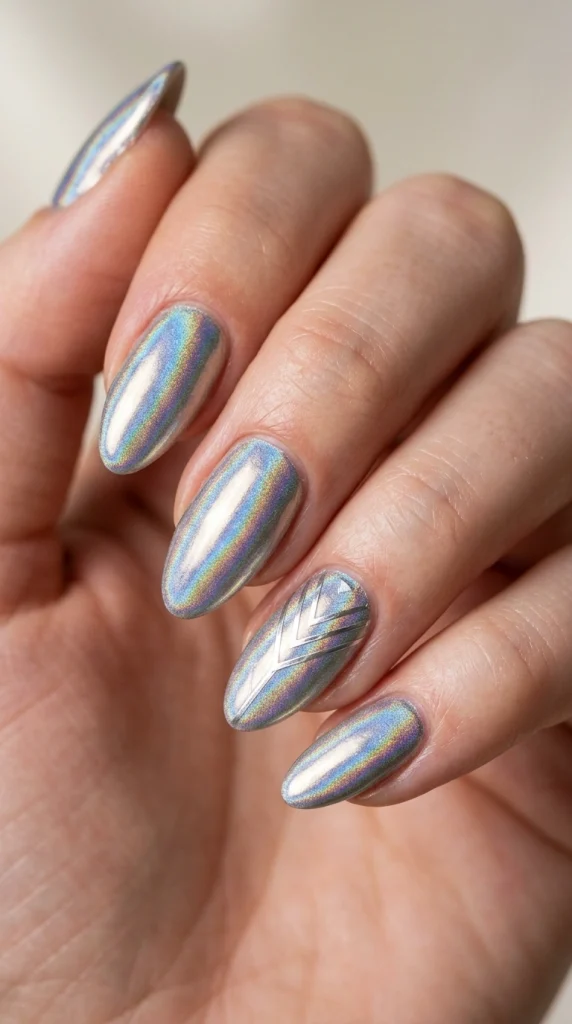Close-up of holographic chrome almond nails with rainbow-reflective shine.