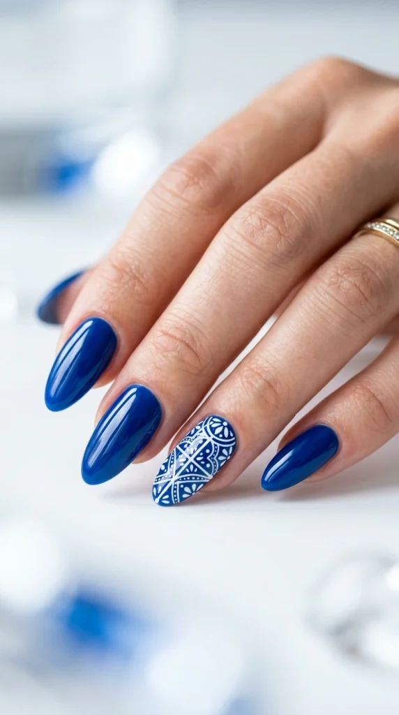 Close-up of glossy cobalt and azure blue almond nails inspired by Mediterranean coastal colors.