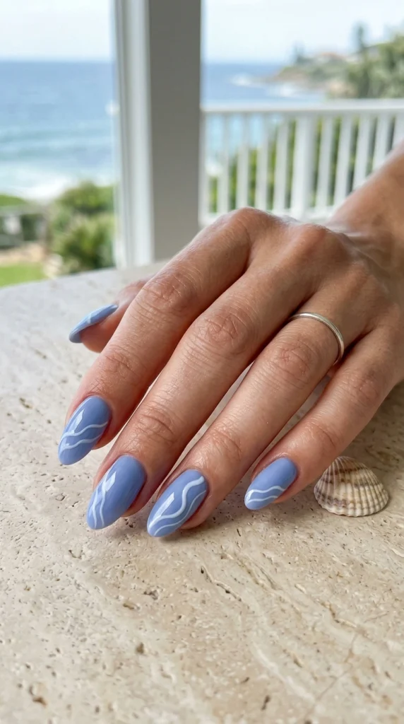 Blueberry cream wave nails with soft white ocean ripples for a coastal summer manicure.