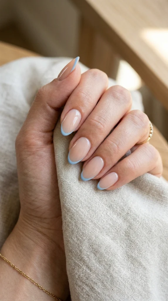 Short almond nails with delicate sky blue micro French tips.
