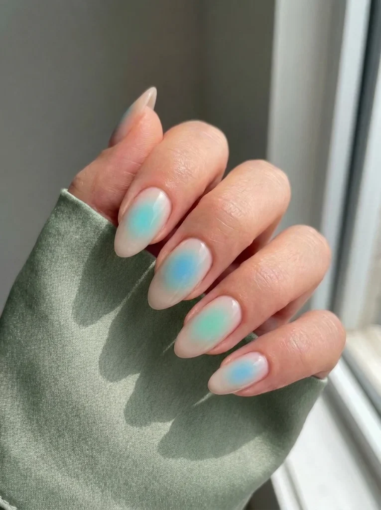 Lagoon Aura manicure with soft aqua and turquoise airbrushed aura gradients on a sheer milky nude base for a dreamy summer nail look.