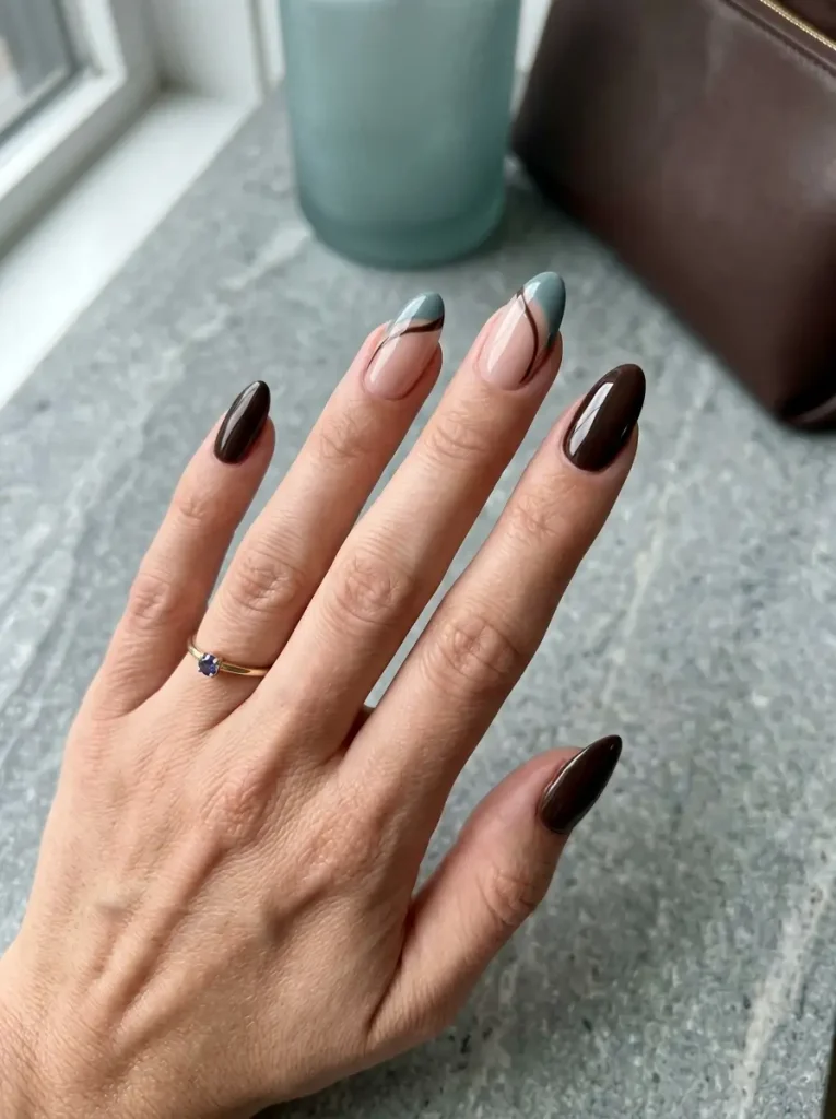 20 Chic September Nail Designs for 2026 That Capture Fall’s First Glow 7 Glossy espresso brown and muted teal almond nails with modern curved accents.
