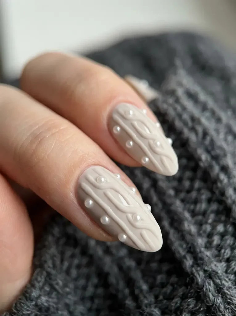 Cable knit nails with small pearl accents set along the raised cable