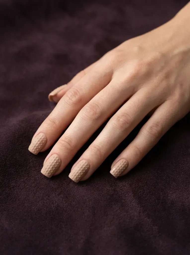 Nude sweater nails with tone on tone knit texture and no color contrast
