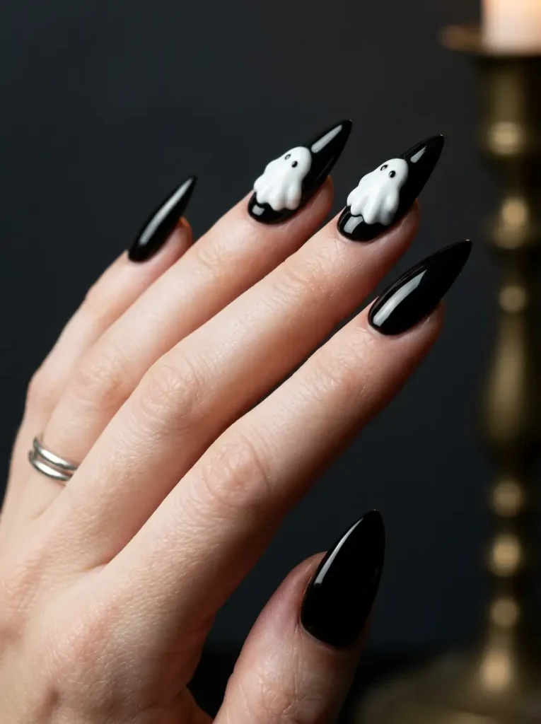 Long stiletto nails in glossy black with raised white 3D builder-gel ghosts on two nails, on a fair skin tone