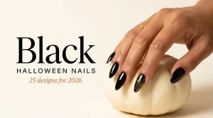 Black Halloween nail designs 2026 cover, glossy black almond nails with a gold web accent on a white pumpkin, tan skin tone