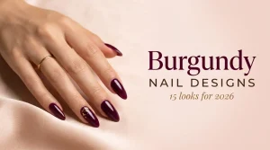 Burgundy nail designs 2026 cover, long almond nails in glossy deep burgundy with gold foil on one nail, medium skin tone