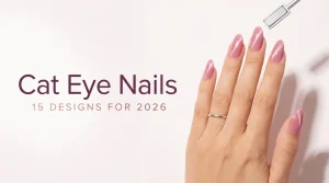 Cat eye nail designs 2026 cover, almond pink cat eye nails with a thin gold ring beside a polish brush, light skin tone