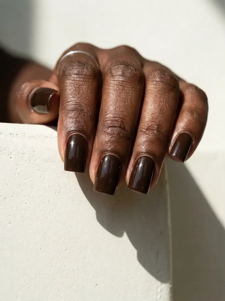 18 Fall Nail Colors for 2026, From Taupe to Navy 6 Espresso brown glossy square nails of medium length, on a deep skin tone