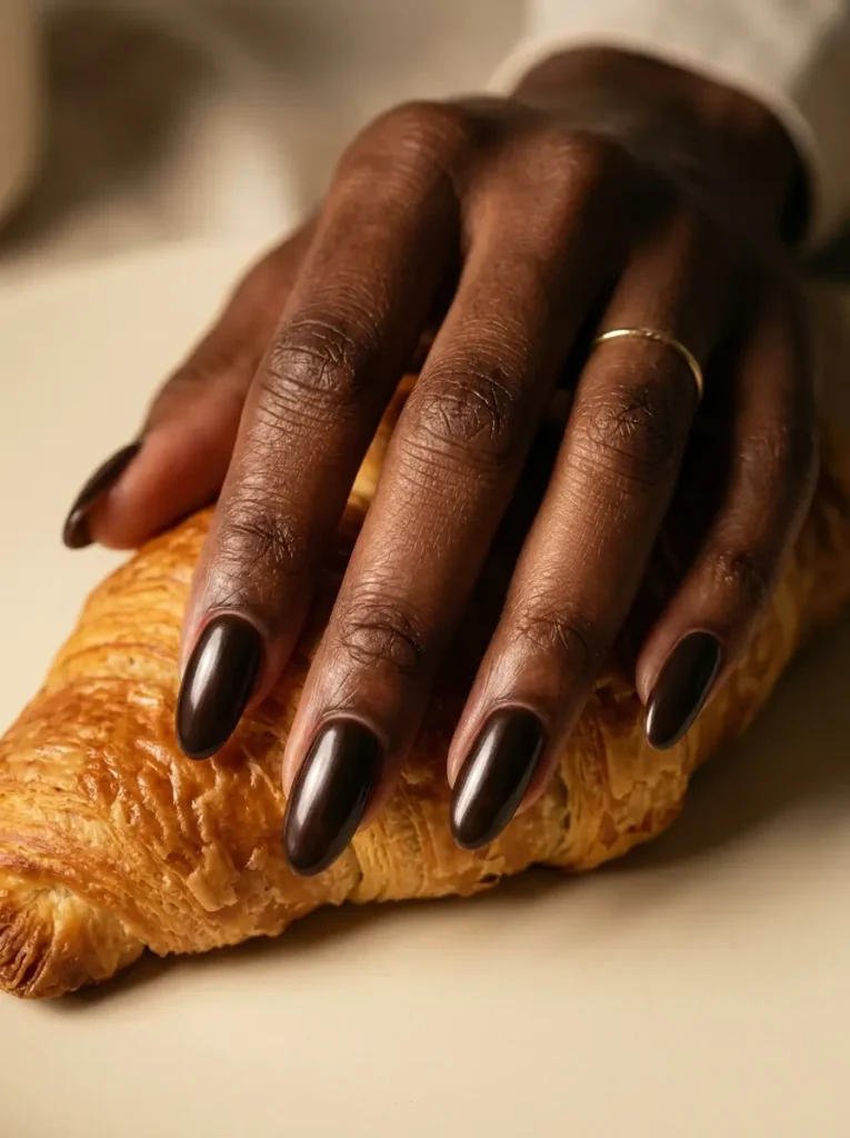 28 Fall Nail Designs for 2026, From Simple to Classy 17 Long oval espresso brown nails with a sheer pearly glaze over every nail, on a deep skin tone