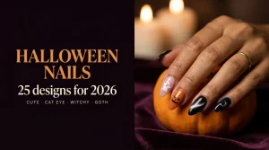 25 Halloween nail designs for 2026 cover, with one hand wearing ghost, pumpkin, cat-eye and moon nail designs holding a mini pumpkin by candlelight