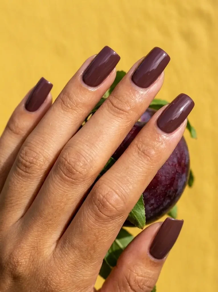 18 Fall Nail Colors for 2026, From Taupe to Navy 10 Plum purple glossy square nails of medium length, on an olive skin tone