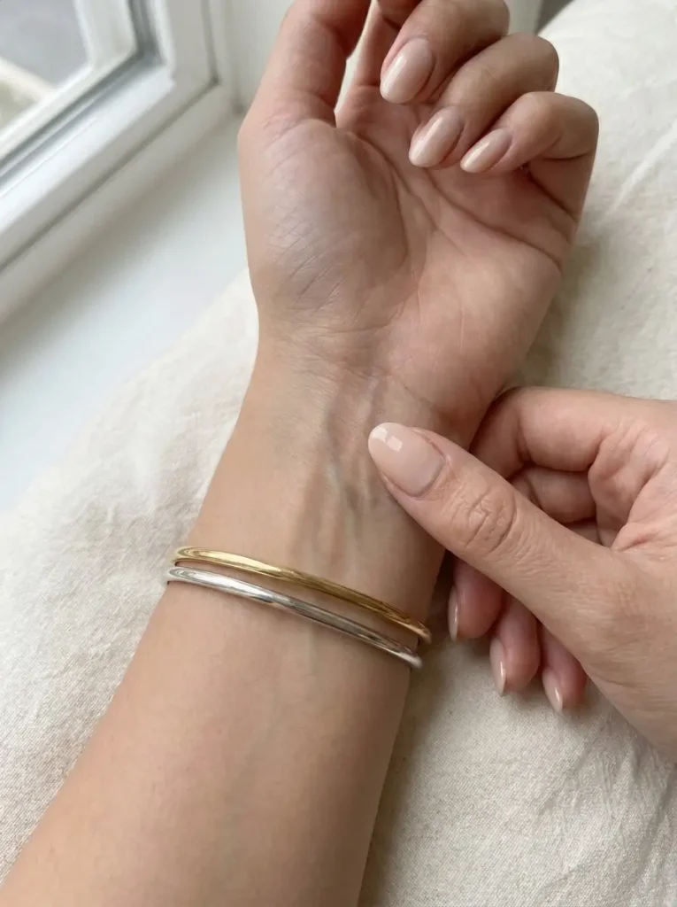 A wrist turned up in natural daylight to check skin undertone