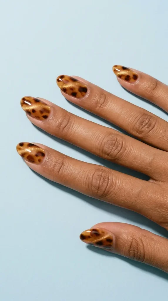 Medium almond tortoiseshell cat eye nails with a soft diagonal band of light floating over amber and caramel blotches